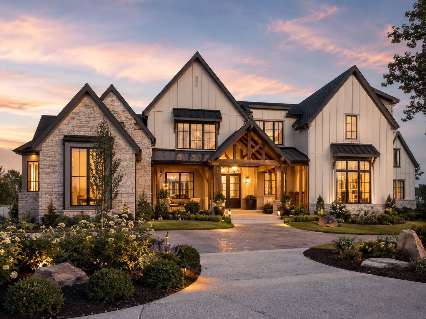 Luxury white farmhouse with stone, timber entry, and metal roof at dusk
